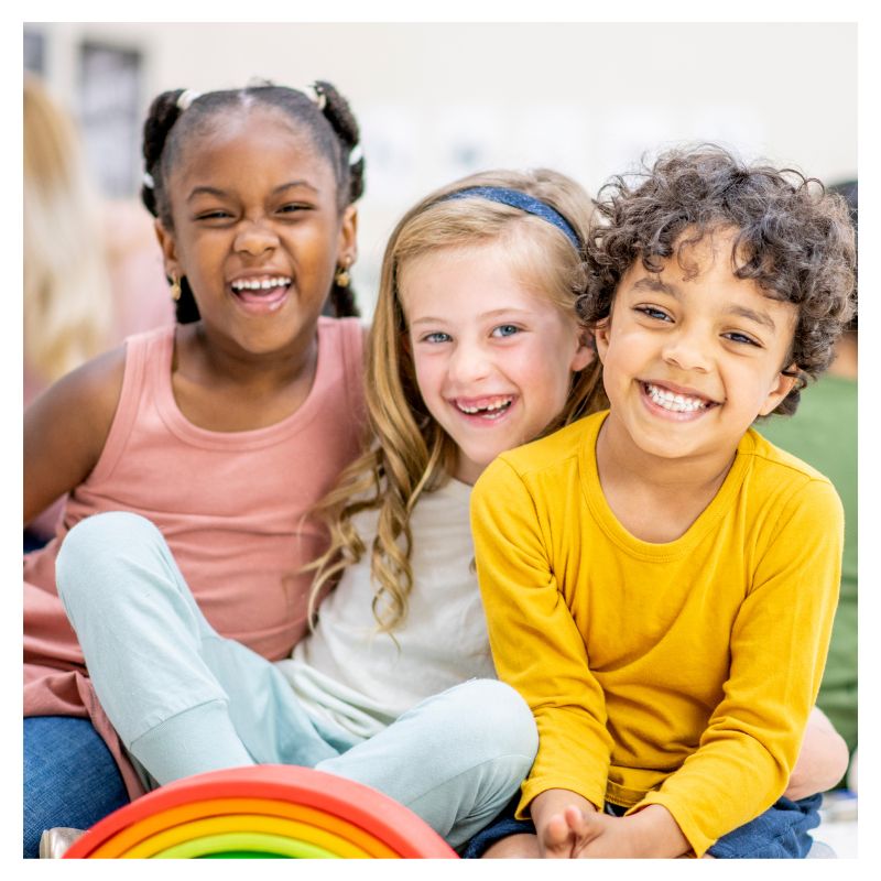 n early childhood reading intervention session inside a primary K-1 classroom, showing an educator actively utilizing the Jumpstart Kinder Science of Reading phonics curriculum and color-coded blending cards to teach small group decoding skills.