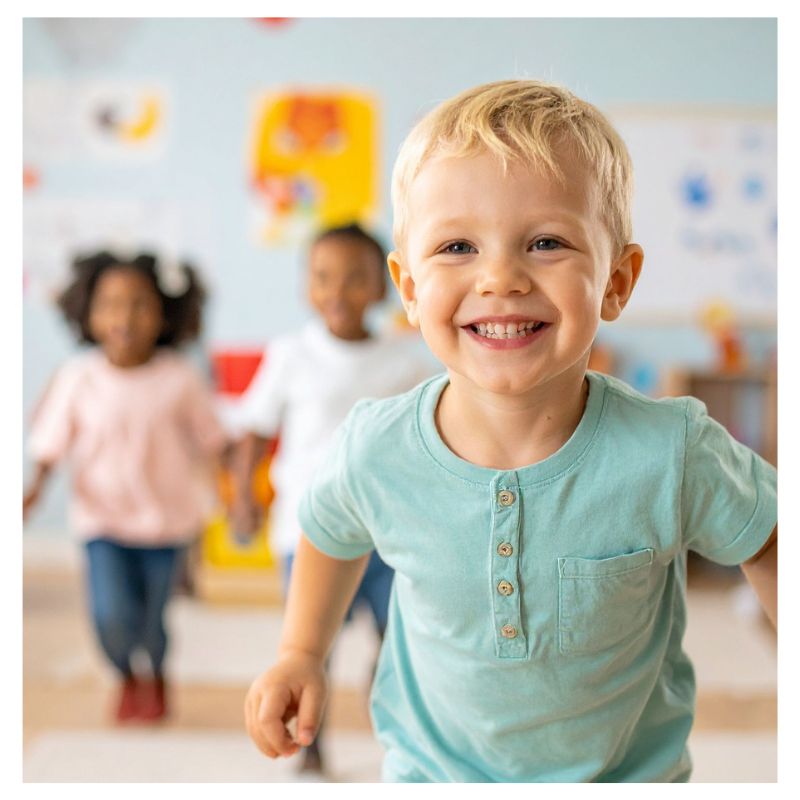 A diverse group of preschool children engaged in interactive, play-based literacy routines inside an early learning daycare center.