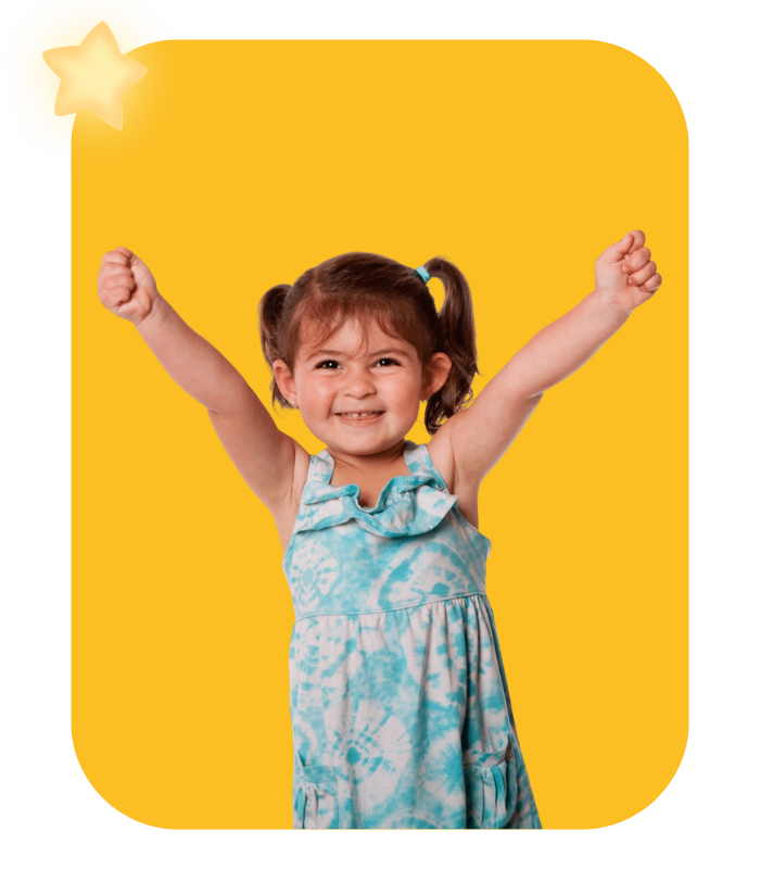 A young girl celebrating with a big smile and her hands raised to the sky, illustrating a successful early reading milestone and kindergarten readiness achieved through a simple, step-by-step phonics method designed to teach your child to read.